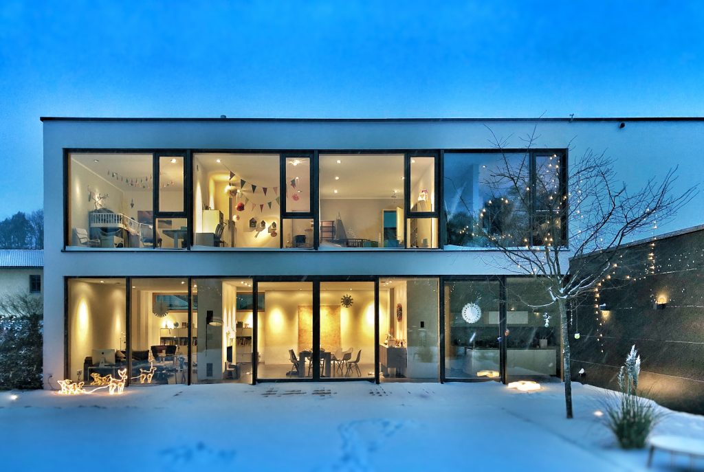 Home with bright interior lights in winter