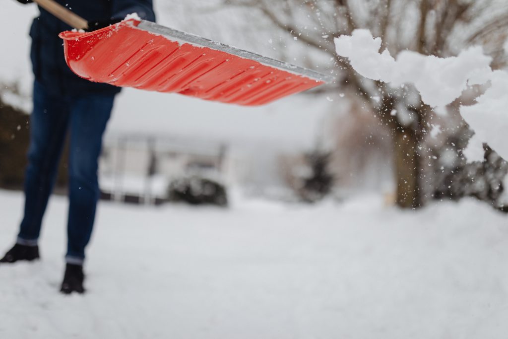 Homeowner shovelling snow in winter